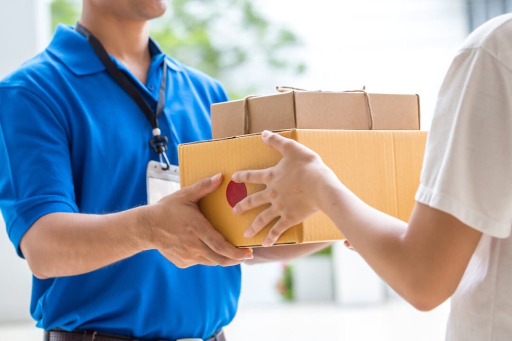 A member happily accepting a delivery